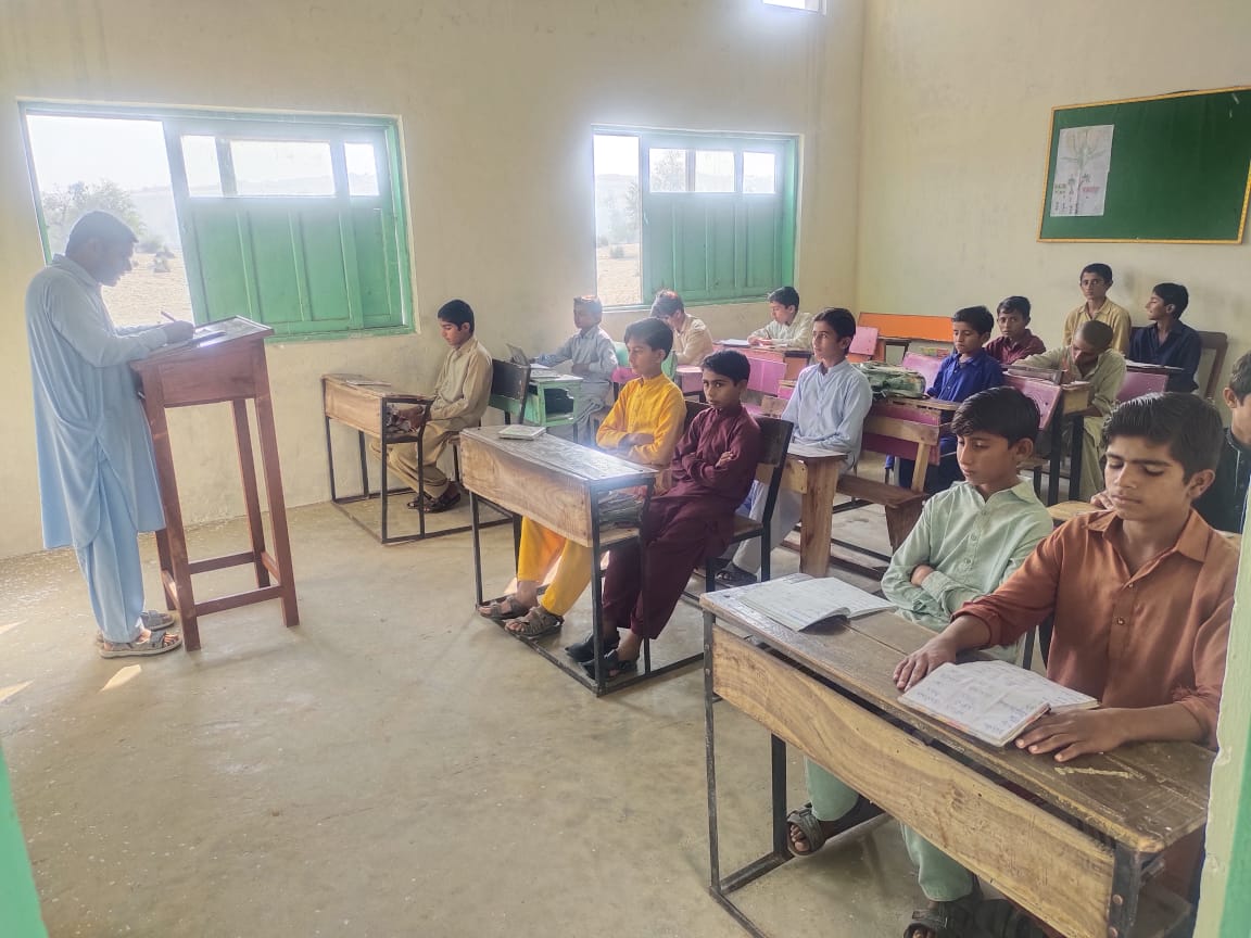 Elder teacher leading a lesson in a sunlit classroom